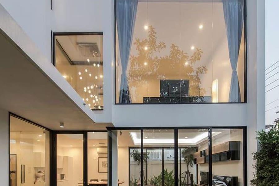Glass and aluminium glazing on a contemporary residential elevation at night