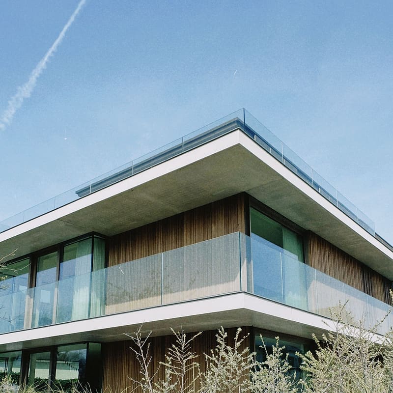 Frameless toughened glass balcony railing on a modern villa
